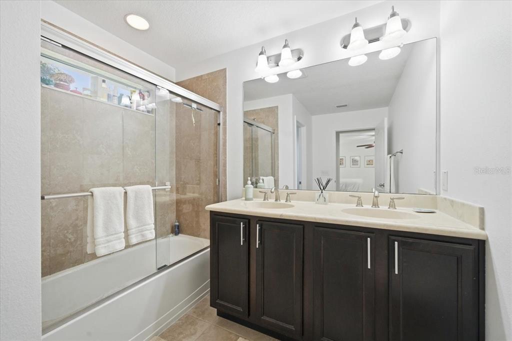 12330 North Rome Avenue Tampa, FL 33612 - Photo 22 of 33 a bathroom with a double vanity sink mirror and bathtub