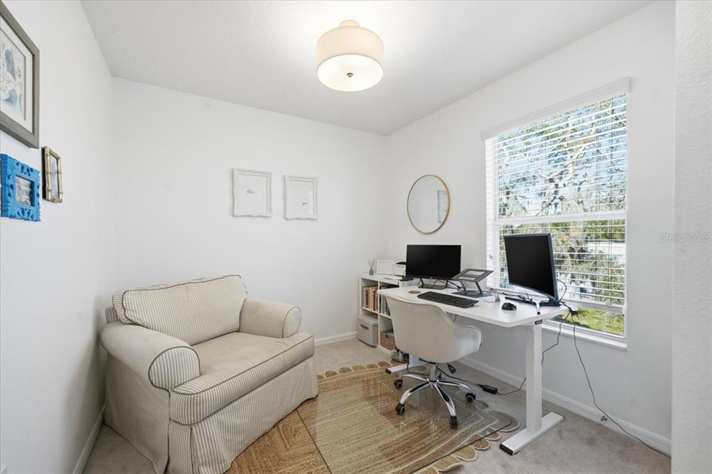 12330 North Rome Avenue Tampa, FL 33612 - Photo 25 of 33 a work room with furniture a clock and a window