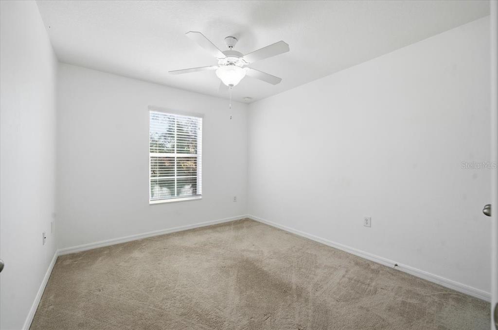 12330 North Rome Avenue Tampa, FL 33612 - Photo 28 of 33 an empty room with windows and chandelier fan