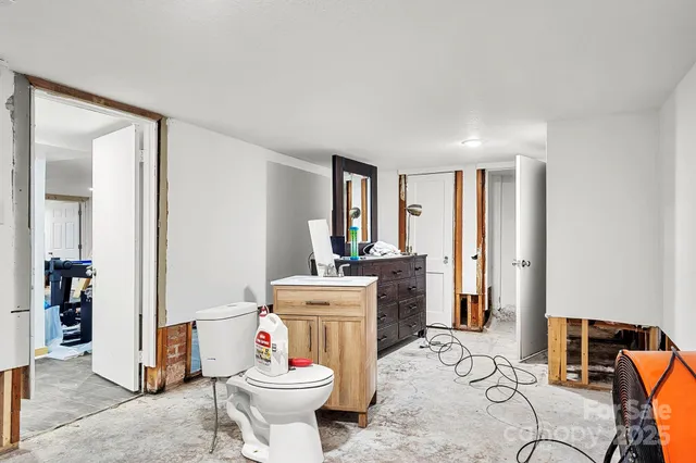 a bathroom with a sink toilet vanity and tub