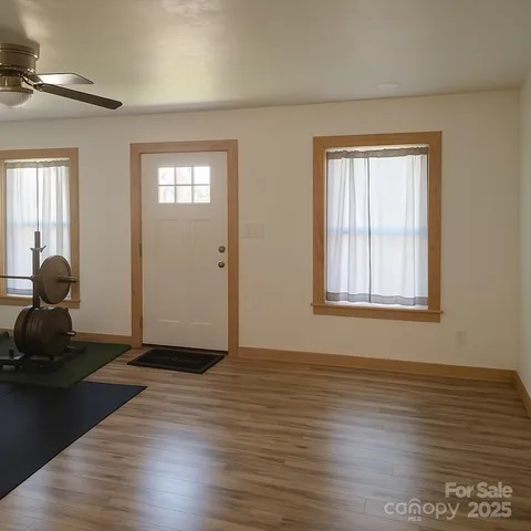 a view of a livingroom with wooden floor and a window