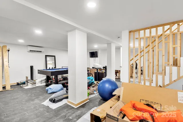 a living room with furniture a window and gym equipment