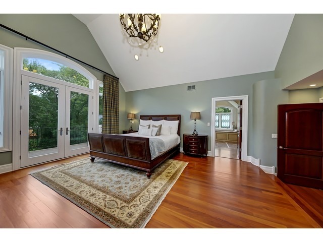 Undisclosed Address Hinsdale, IL 60521 - Photo 13 of 30 a spacious bedroom with a bed a dresser and wooden floor