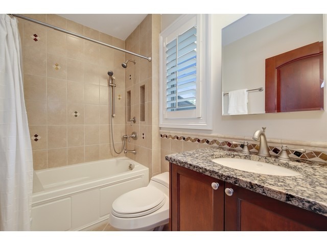 Undisclosed Address Hinsdale, IL 60521 - Photo 17 of 30 a bathroom with a granite countertop sink toilet and shower