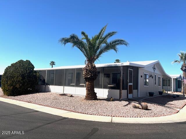 834 South Meridian Road, Unit 118 Apache Junction, AZ 85120 - Photo 42 of 50 a view of a house with a yard and potted plants