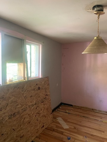Undisclosed Address Chicago, IL 60620 - Photo 6 of 7 a view of empty room with wooden floor and fan
