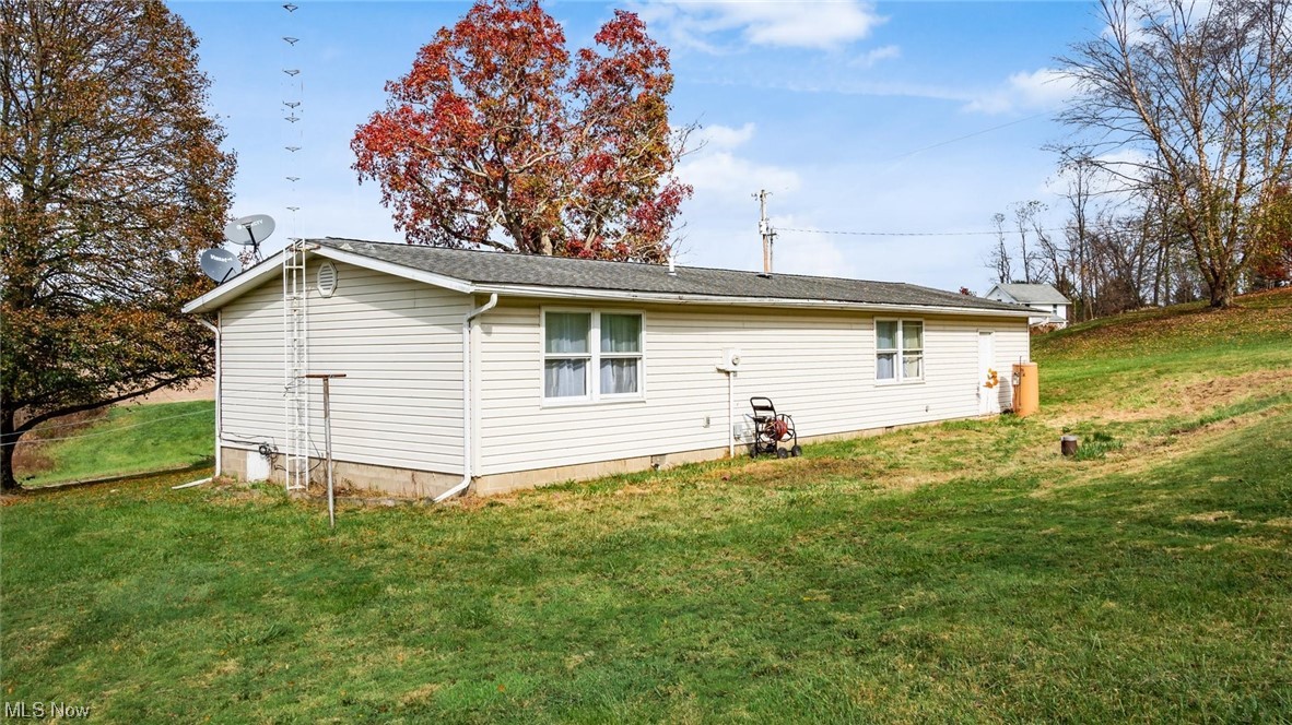 1730 Mollies Rock Road Dresden, OH 43821 - Photo 22 of 24 View of side of home with a yard