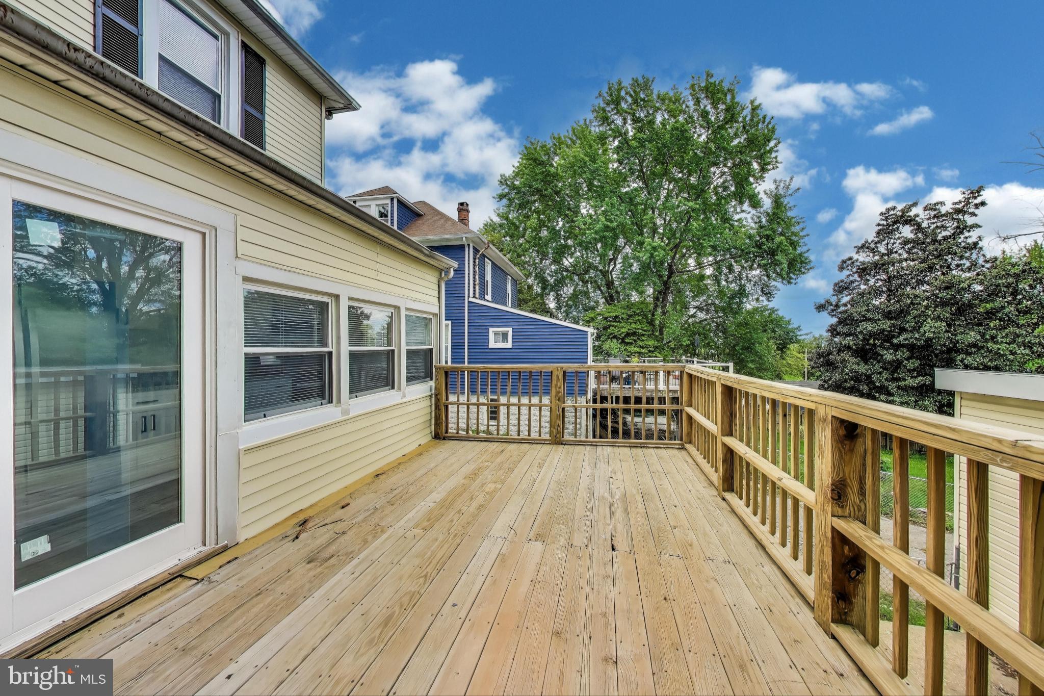 1 Maple Avenue Baltimore, MD 21206 - Photo 19 of 53 a view of a balcony with wooden floor and fence