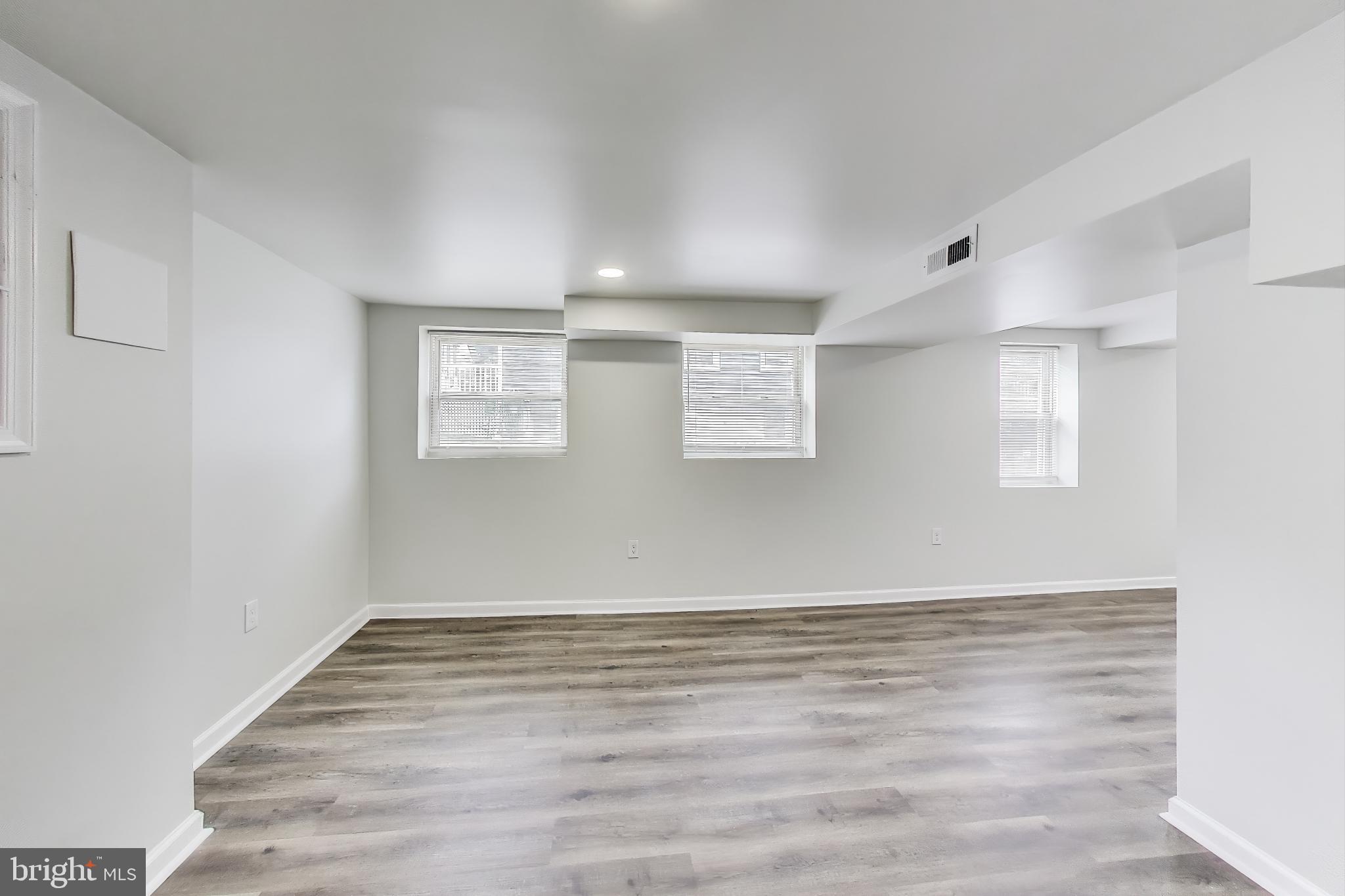 1 Maple Avenue Baltimore, MD 21206 - Photo 23 of 53 a view of wooden floor and windows in a room