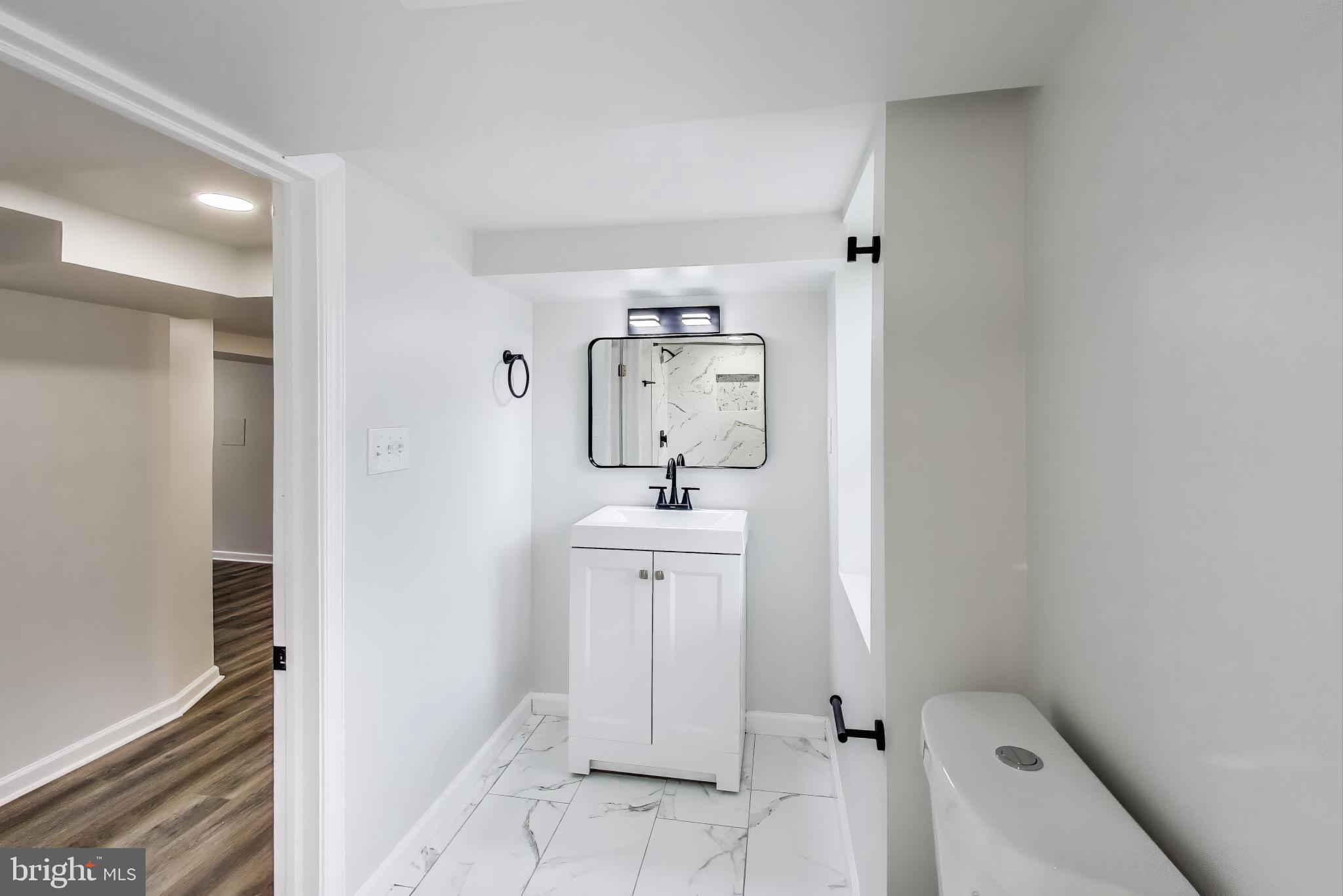 1 Maple Avenue Baltimore, MD 21206 - Photo 26 of 53 a bathroom with a sink mirror and toilet