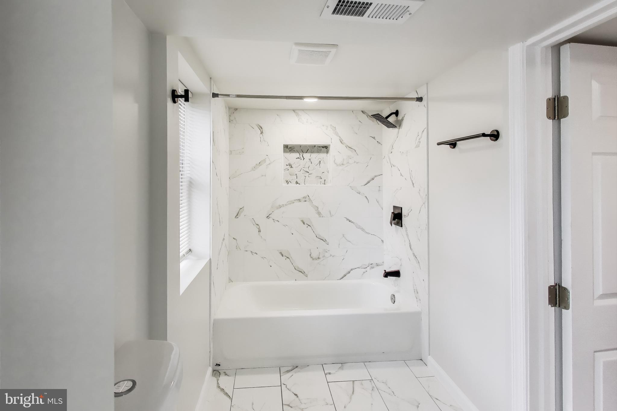 1 Maple Avenue Baltimore, MD 21206 - Photo 27 of 53 a bathroom with a bathtub and a shower