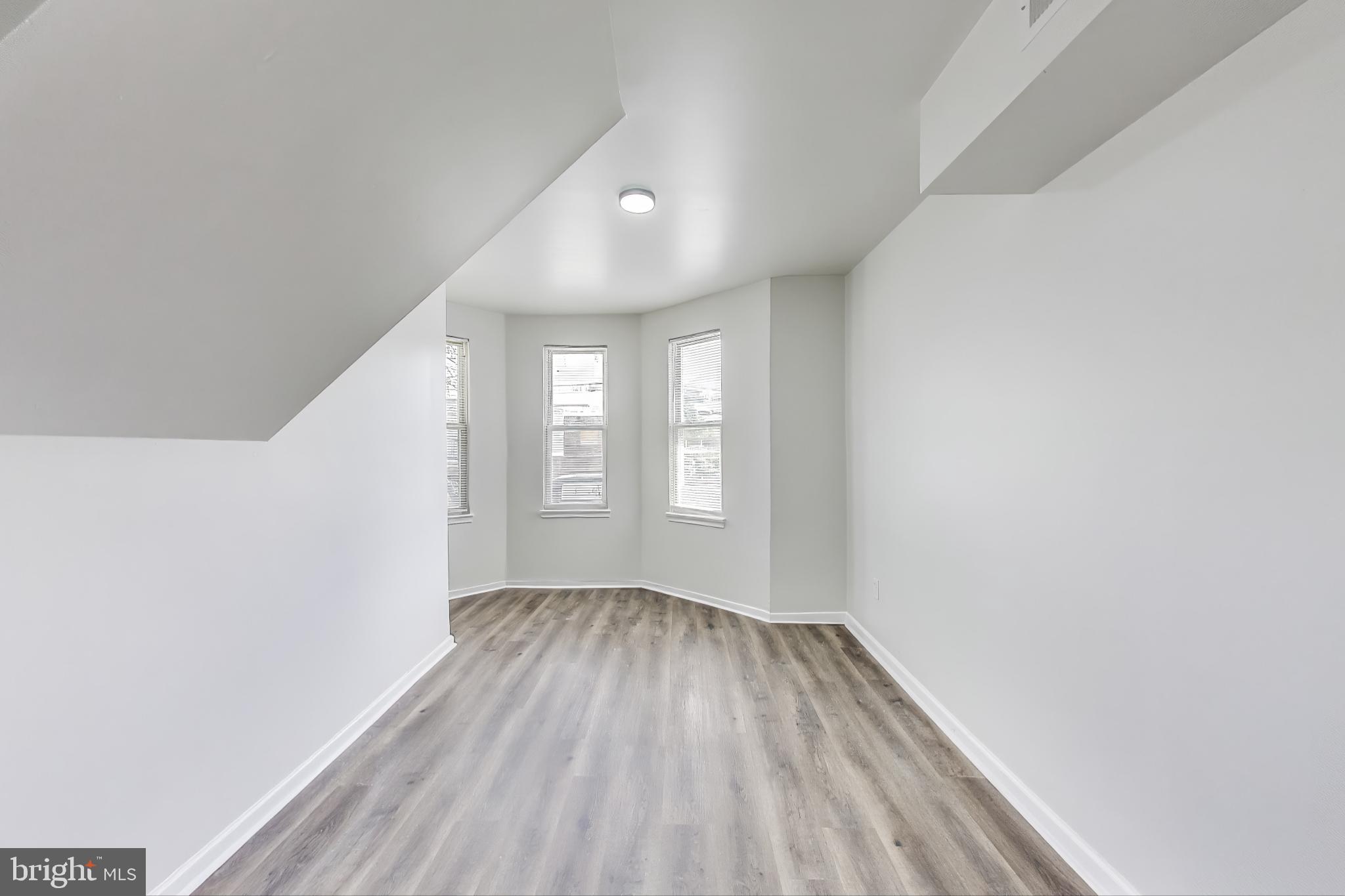 1 Maple Avenue Baltimore, MD 21206 - Photo 29 of 53 wooden floor in an empty room with a window