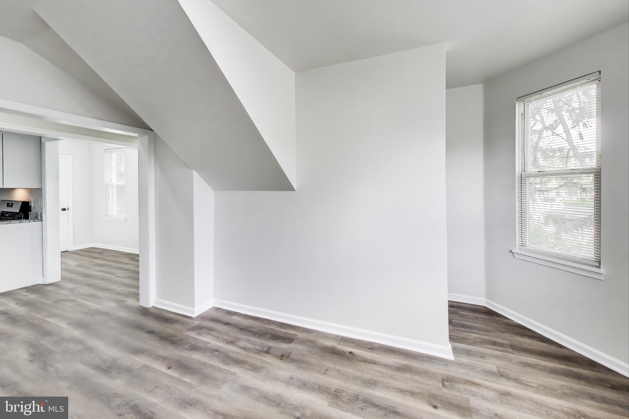 1 Maple Avenue Baltimore, MD 21206 - Photo 30 of 53 an empty room with wooden floor and windows