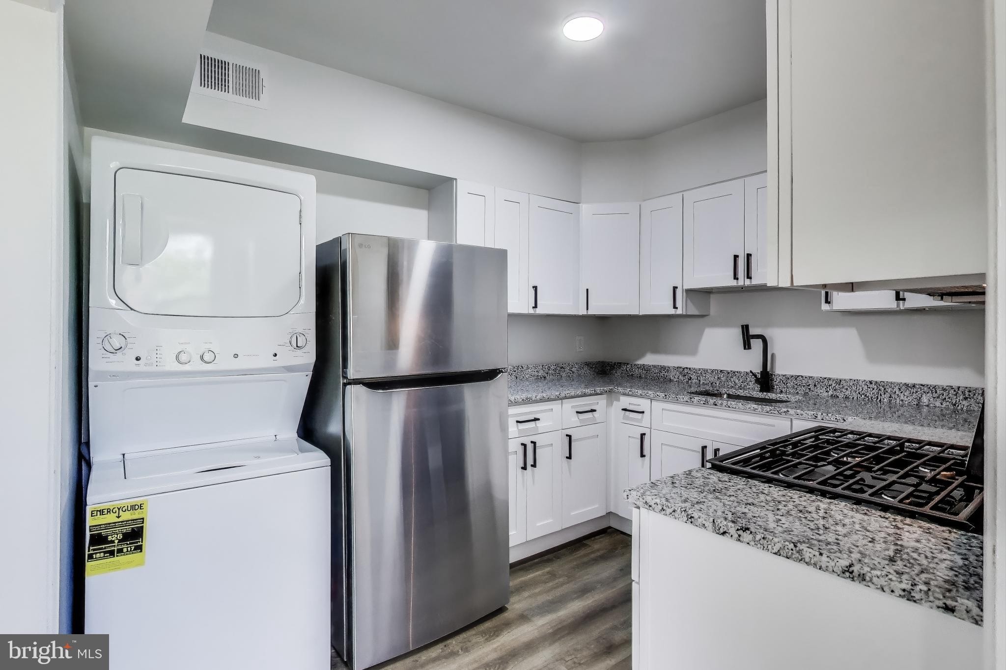 1 Maple Avenue Baltimore, MD 21206 - Photo 32 of 53 a kitchen with a stove a refrigerator and cabinets