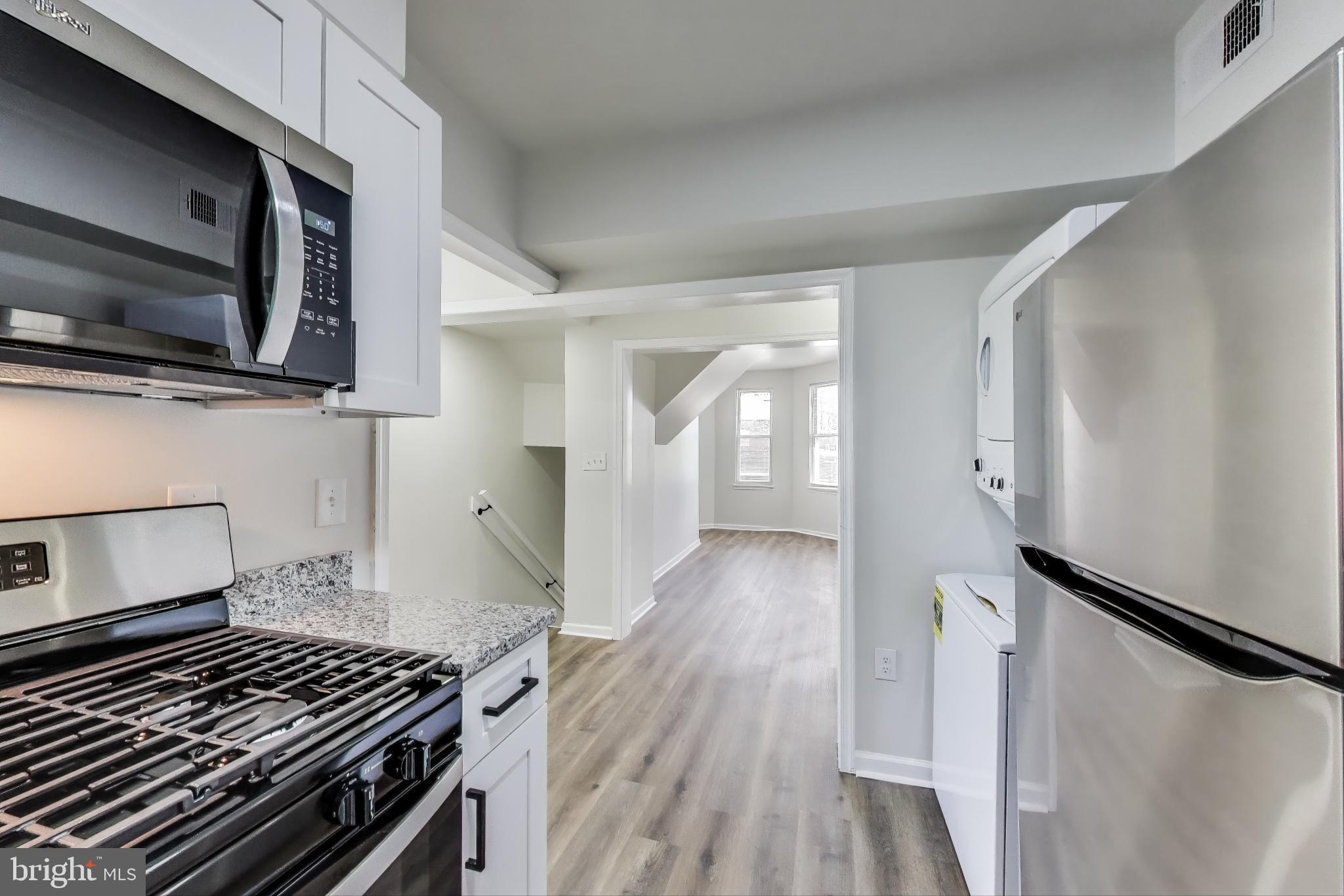 1 Maple Avenue Baltimore, MD 21206 - Photo 34 of 53 a kitchen with wooden floor a sink and a stove