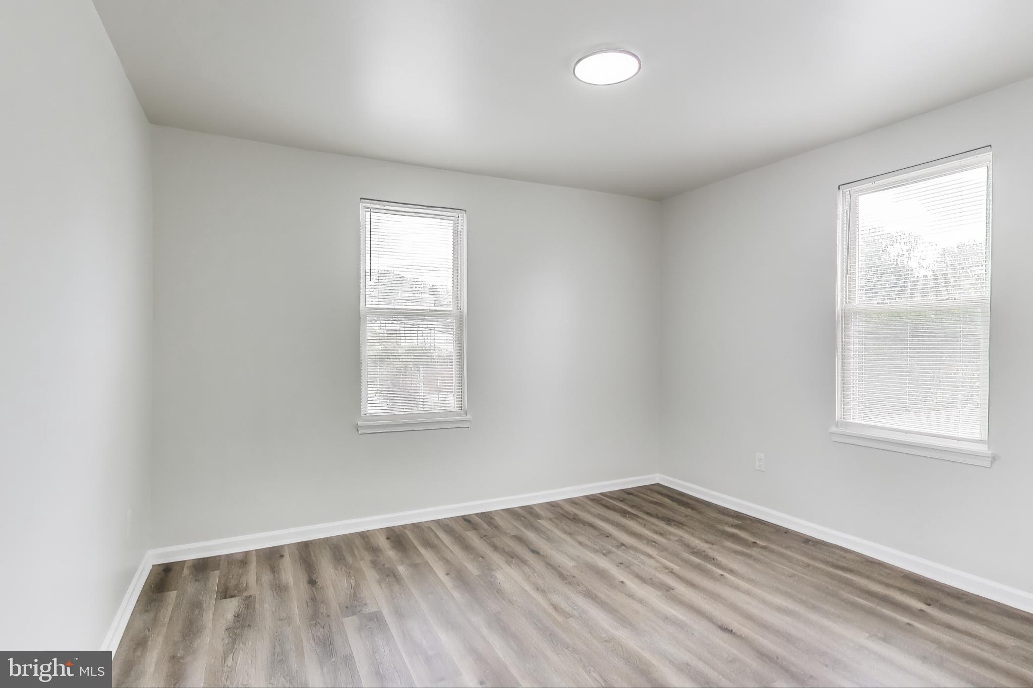 1 Maple Avenue Baltimore, MD 21206 - Photo 37 of 53 an empty room with wooden floor and windows