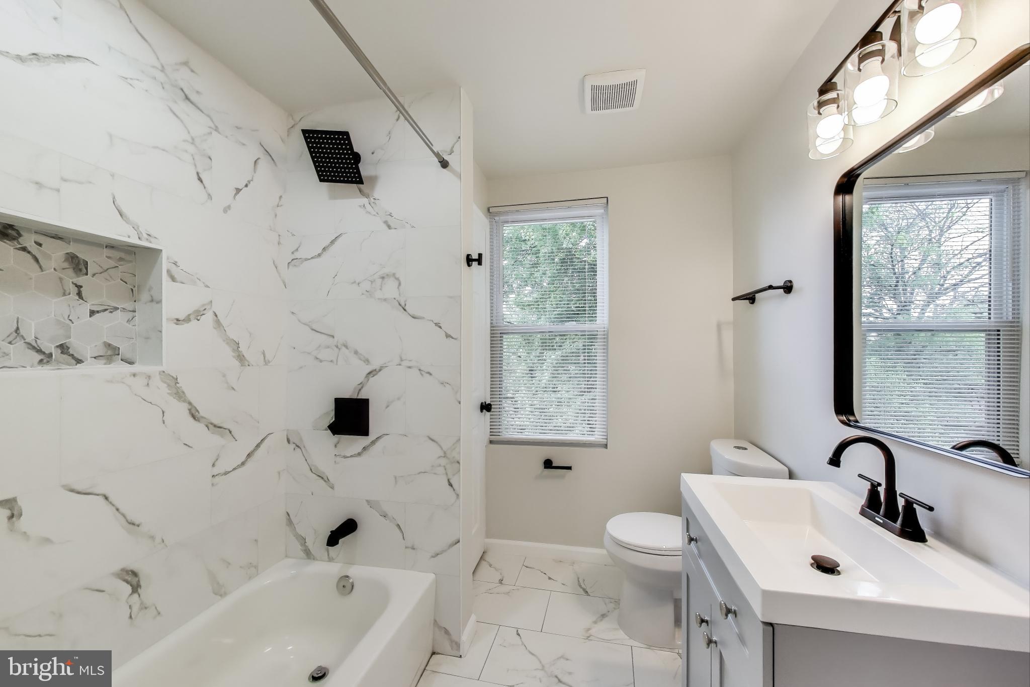 1 Maple Avenue Baltimore, MD 21206 - Photo 39 of 53 a bathroom with a sink toilet a shower and bathtub