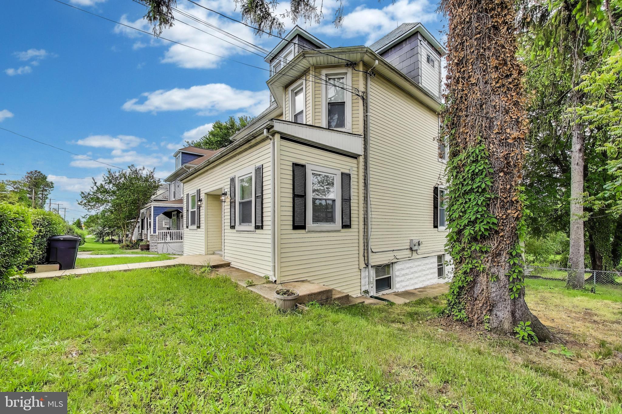 1 Maple Avenue Baltimore, MD 21206 - Photo 4 of 53 a front view of a house with a garden