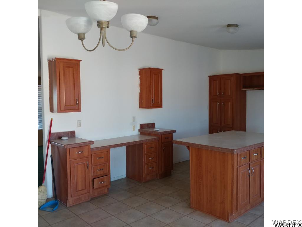 586 Bacobi Road Golden Valley, AZ 86413 - Photo 18 of 36 a room with cabinets and chandelier