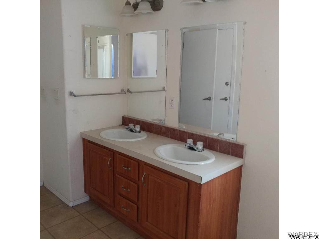 586 Bacobi Road Golden Valley, AZ 86413 - Photo 27 of 36 a bathroom with a sink and a mirror
