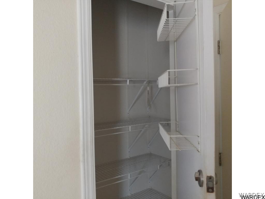 586 Bacobi Road Golden Valley, AZ 86413 - Photo 28 of 36 a walk in closet with wooden floor