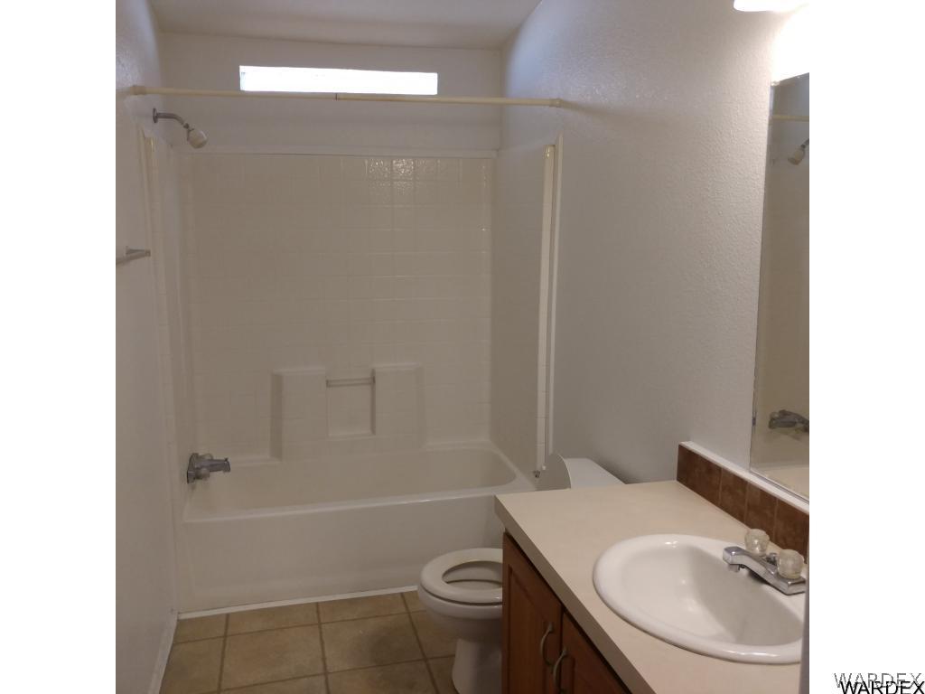 586 Bacobi Road Golden Valley, AZ 86413 - Photo 29 of 36 a bathroom with a sink a toilet and shower