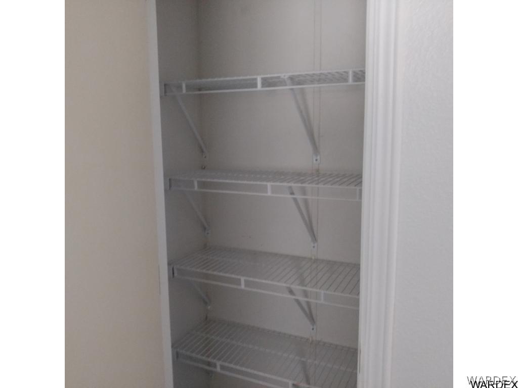 586 Bacobi Road Golden Valley, AZ 86413 - Photo 30 of 36 a view of walk in closet with empty racks