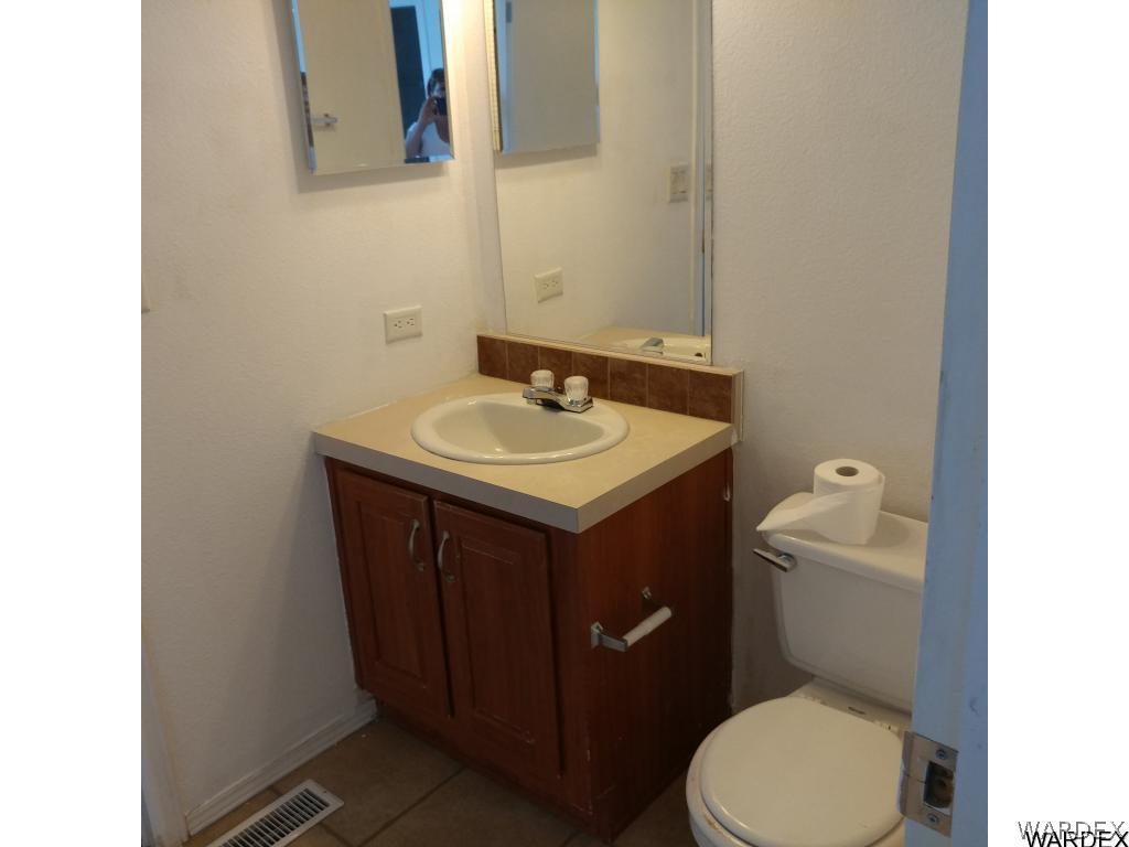 586 Bacobi Road Golden Valley, AZ 86413 - Photo 31 of 36 a bathroom with a sink and a toilet