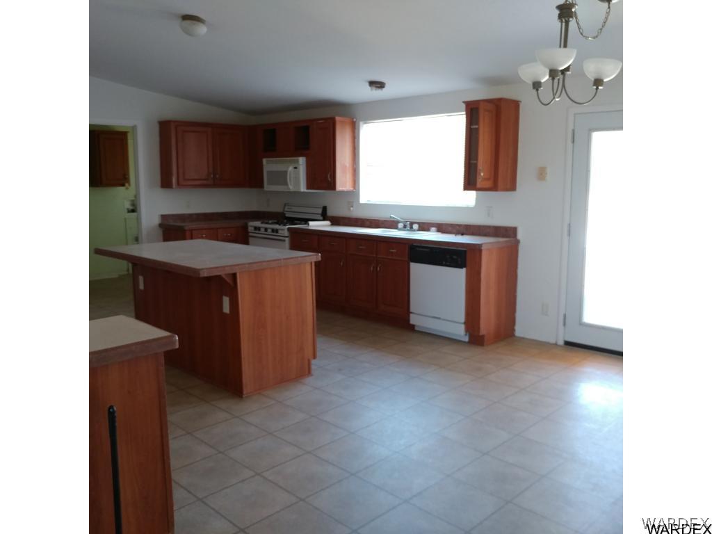 586 Bacobi Road Golden Valley, AZ 86413 - Photo 33 of 36 a kitchen with a sink counter top space and appliances