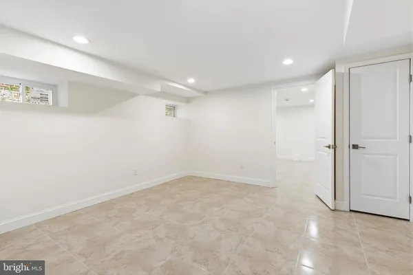 an empty room with a empty space and windows