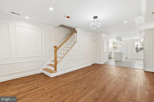 a view of entryway and hall with wooden floor