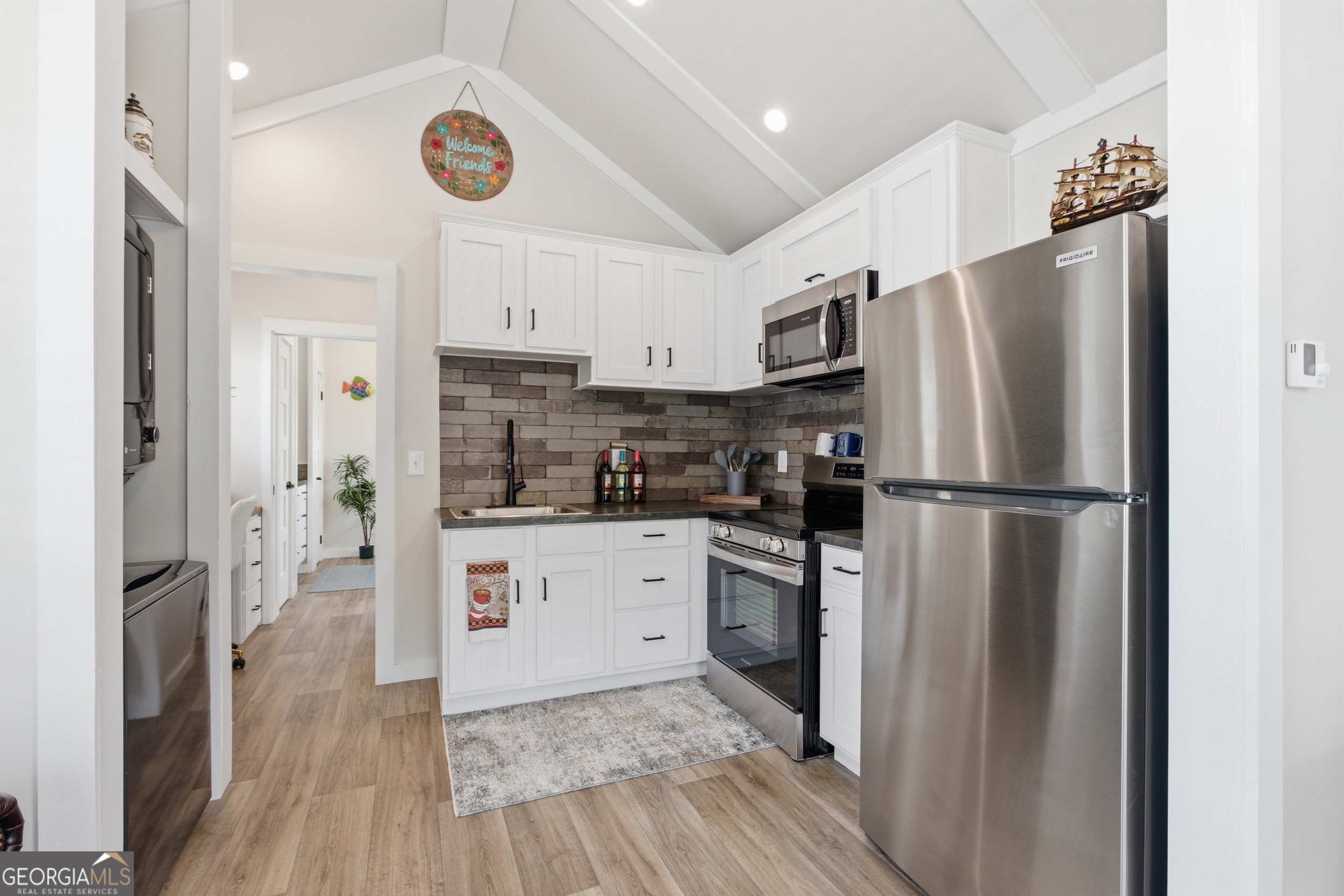 4960 Laurel Lodge Road, Unit 40 Clarkesville, GA 30523 - Photo 11 of 33 a kitchen with stainless steel appliances a refrigerator sink and microwave