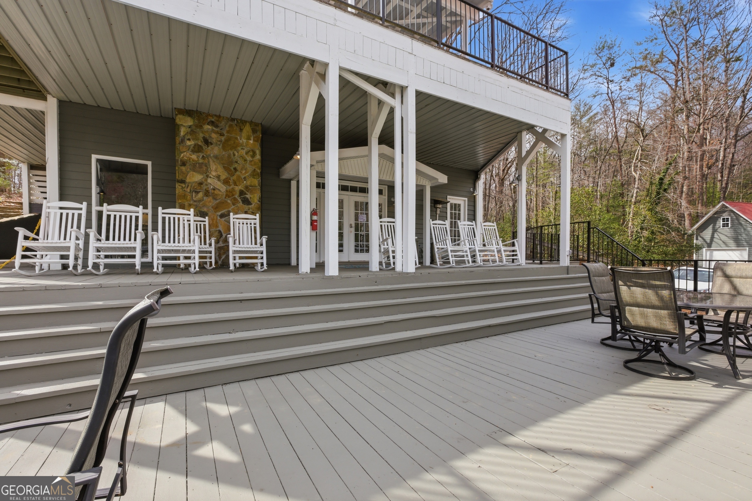4960 Laurel Lodge Road, Unit 40 Clarkesville, GA 30523 - Photo 26 of 33 a view of a patio with table and chairs with wooden floor and fence