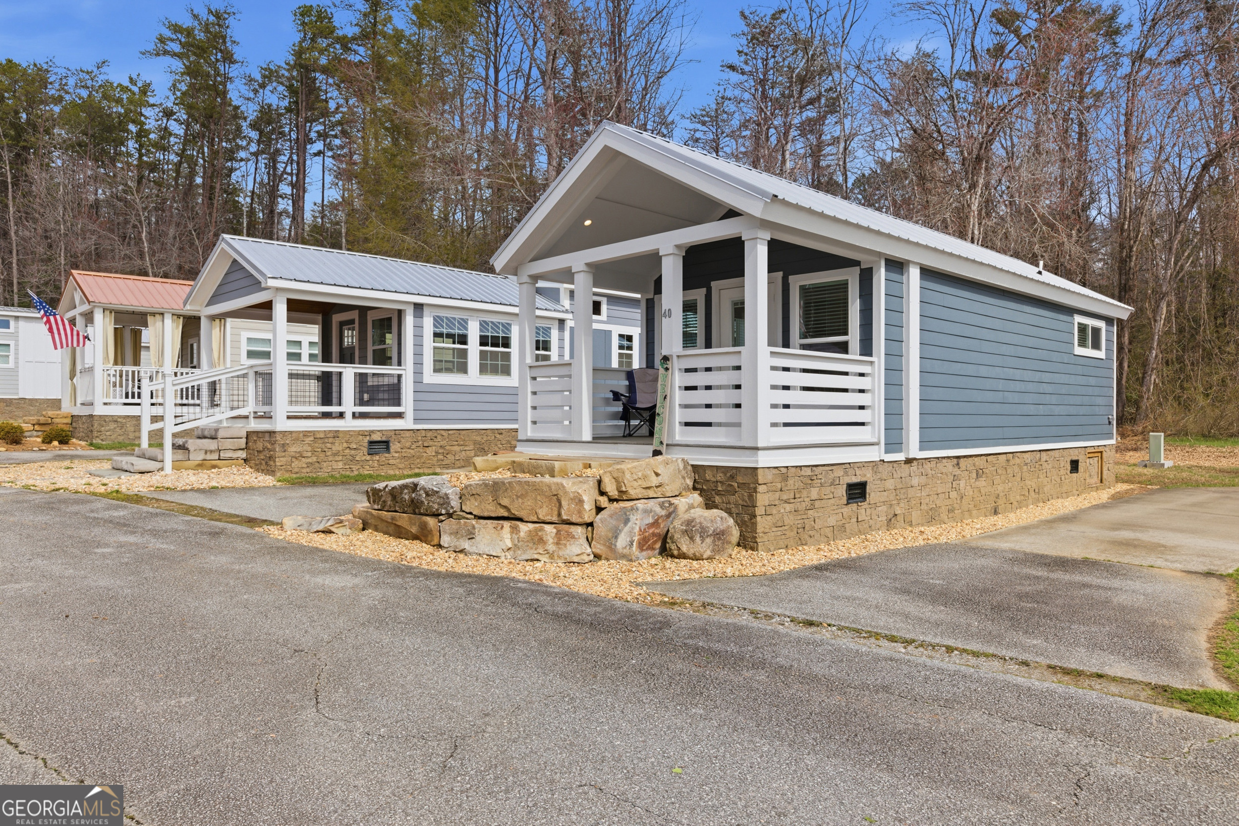 4960 Laurel Lodge Road, Unit 40 Clarkesville, GA 30523 - Photo 3 of 33 a view of a white house with a large space and large windows