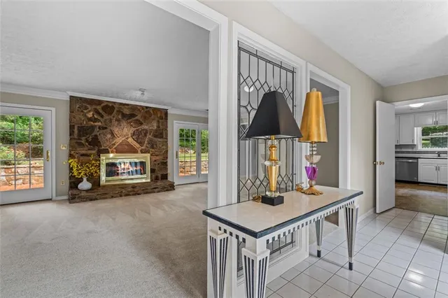 a view of a hallway with wooden floor and a bathroom