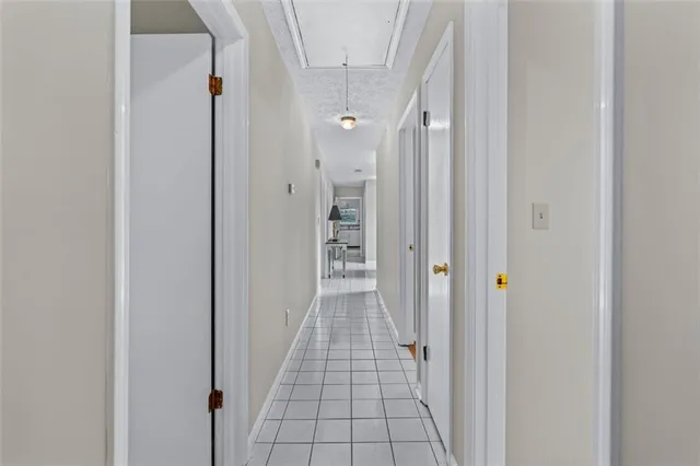 a view of an empty room with a fireplace and a window