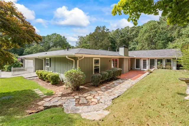 a front view of house with yard and green space