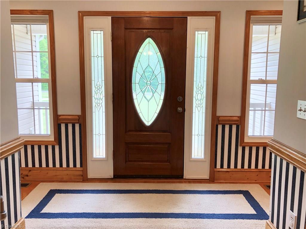261 Running Creek Road Browns Summit, NC 27214 - Photo 3 of 28 Beautiful glassed Entry with hardwoods, wood trim and two coat closets.