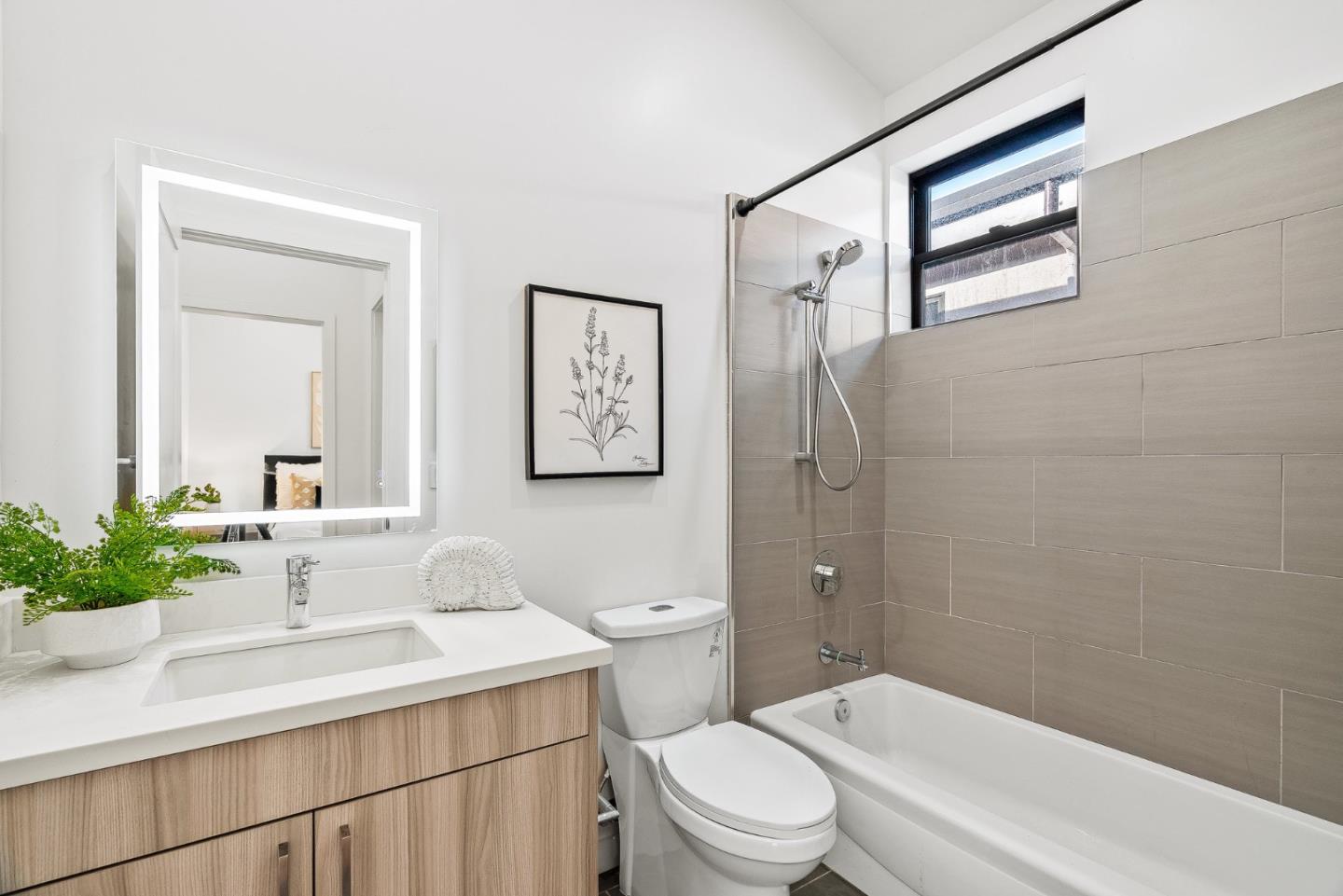 908 Woodside Road Redwood City, CA 94061 - Photo 22 of 26 a bathroom with a sink a toilet and shower