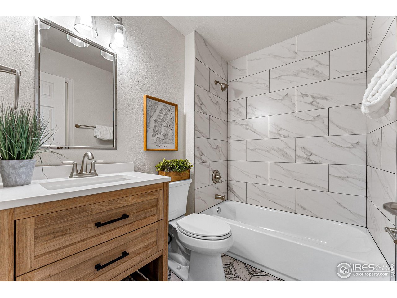 216 Summit Circle Lafayette, CO 80026 - Photo 20 of 35 a bathroom with a granite countertop sink a toilet a mirror and bathtub