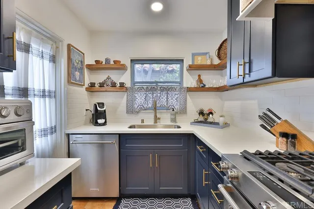 a kitchen with a sink cabinets and stainless steel appliances
