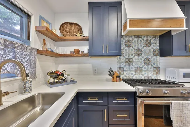 a kitchen with a sink stove and cabinets