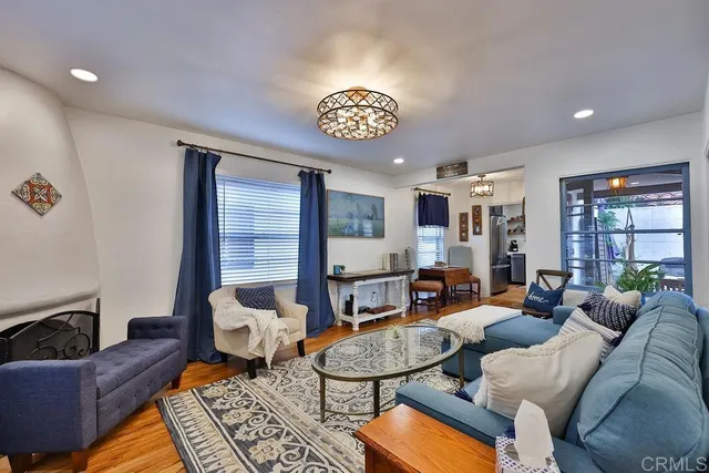 a living room with furniture and wooden floor