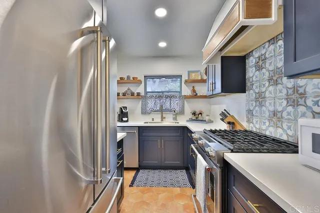 a kitchen with a refrigerator and a stove
