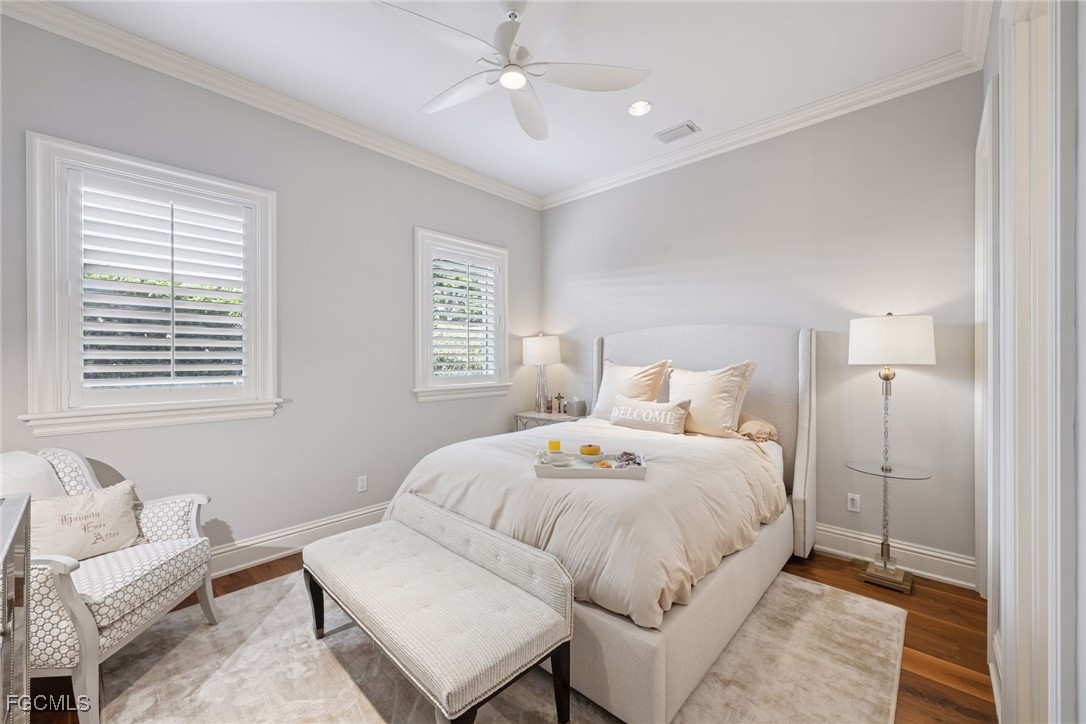 361 Pirates Bight Naples, FL 34103 - Photo 12 of 33 a bedroom with a bed and a couch