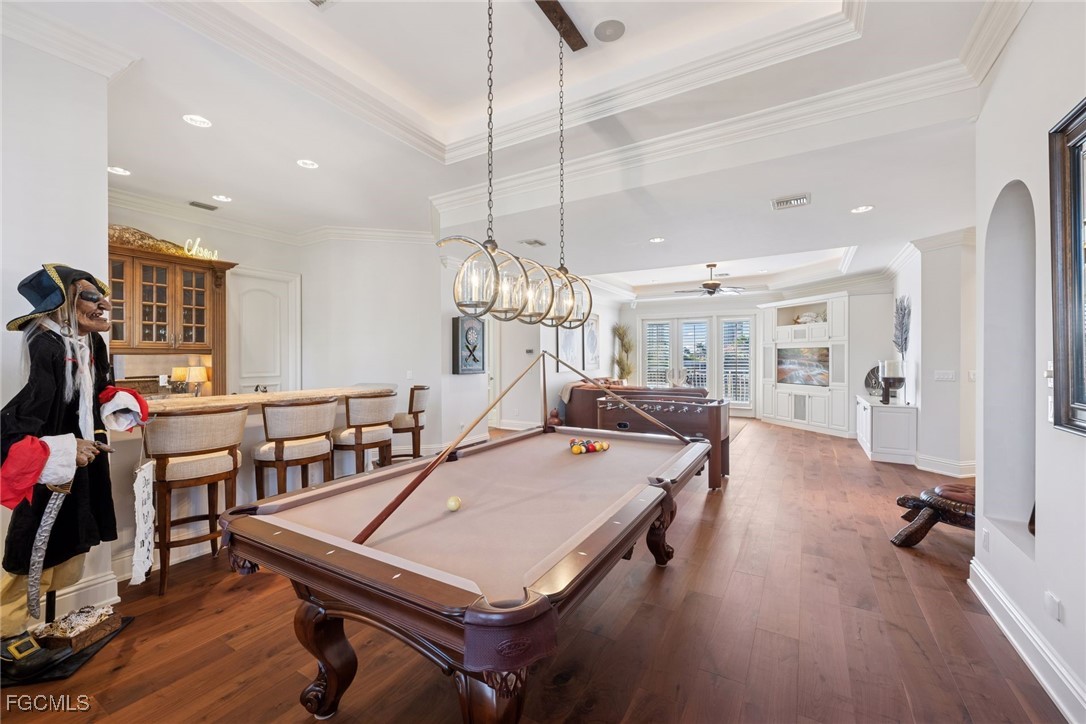 361 Pirates Bight Naples, FL 34103 - Photo 16 of 33 a room with gym equipment and wooden floor