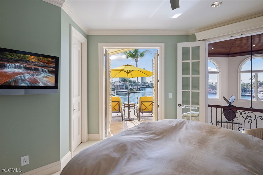 361 Pirates Bight Naples, FL 34103 - Photo 20 of 33 a bedroom with furniture and a window