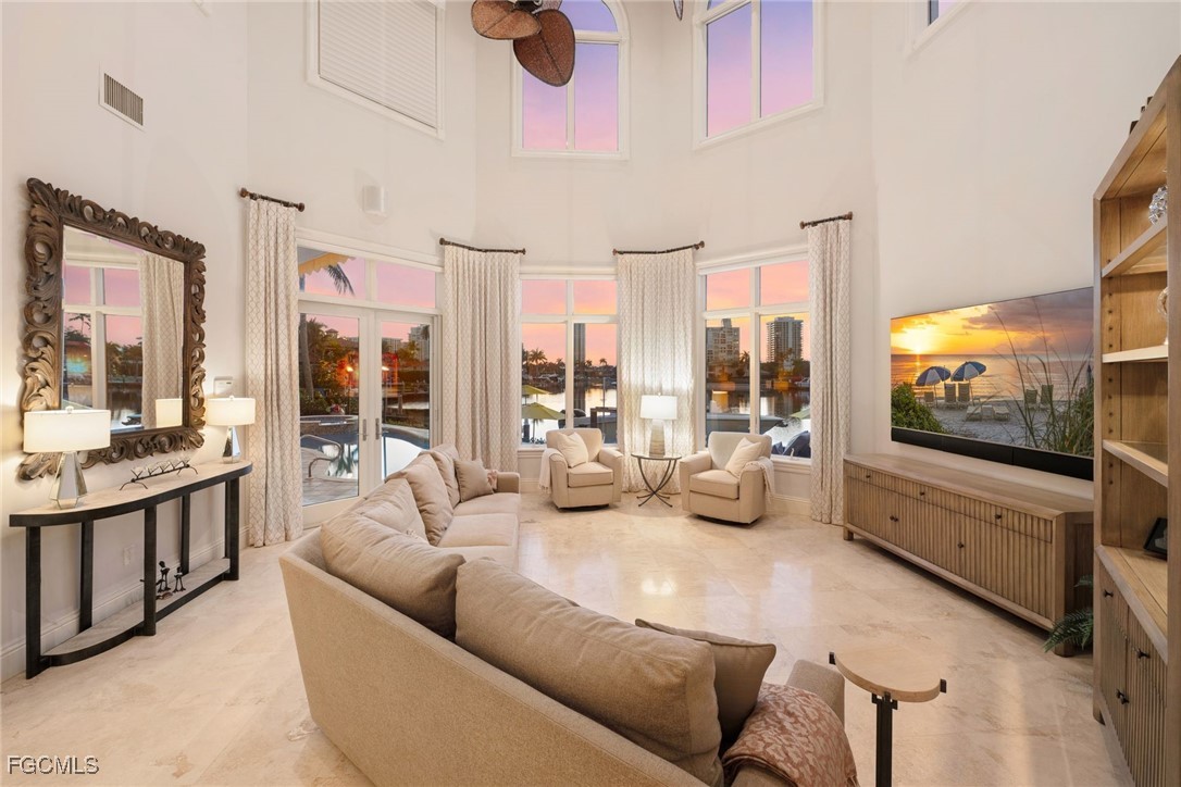 361 Pirates Bight Naples, FL 34103 - Photo 26 of 33 a living room with furniture and a flat screen tv