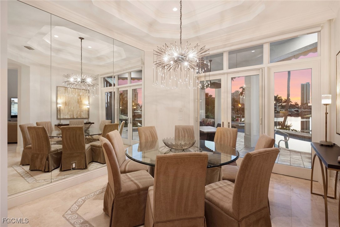 361 Pirates Bight Naples, FL 34103 - Photo 27 of 33 a dining room with furniture a chandelier and window