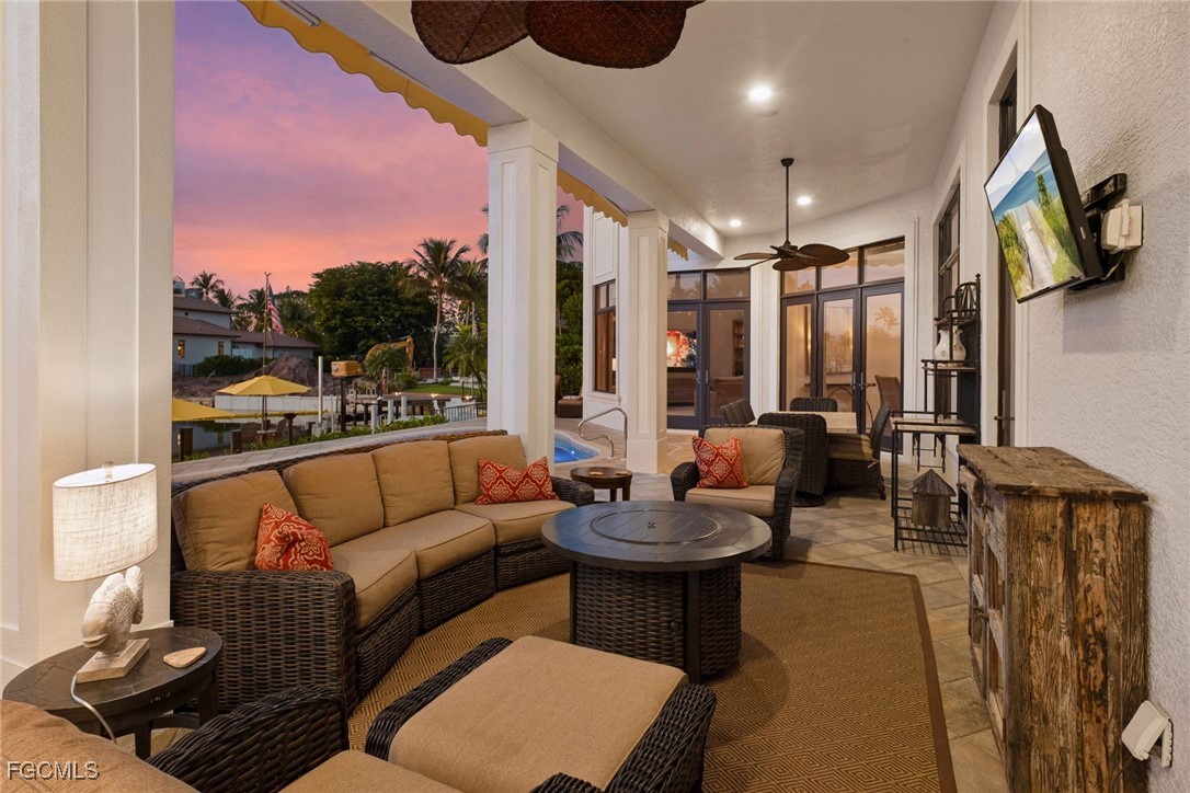 361 Pirates Bight Naples, FL 34103 - Photo 29 of 33 a living room with furniture and a flat screen tv